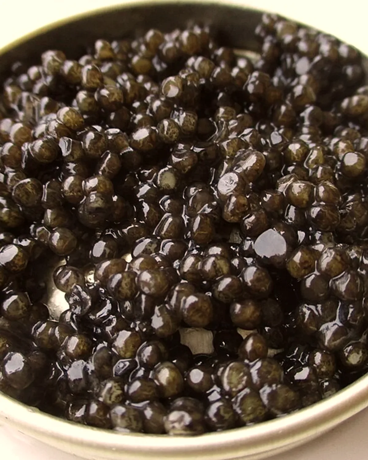 Une boîte ouverte de caviar, ses grains noirs et brillants.